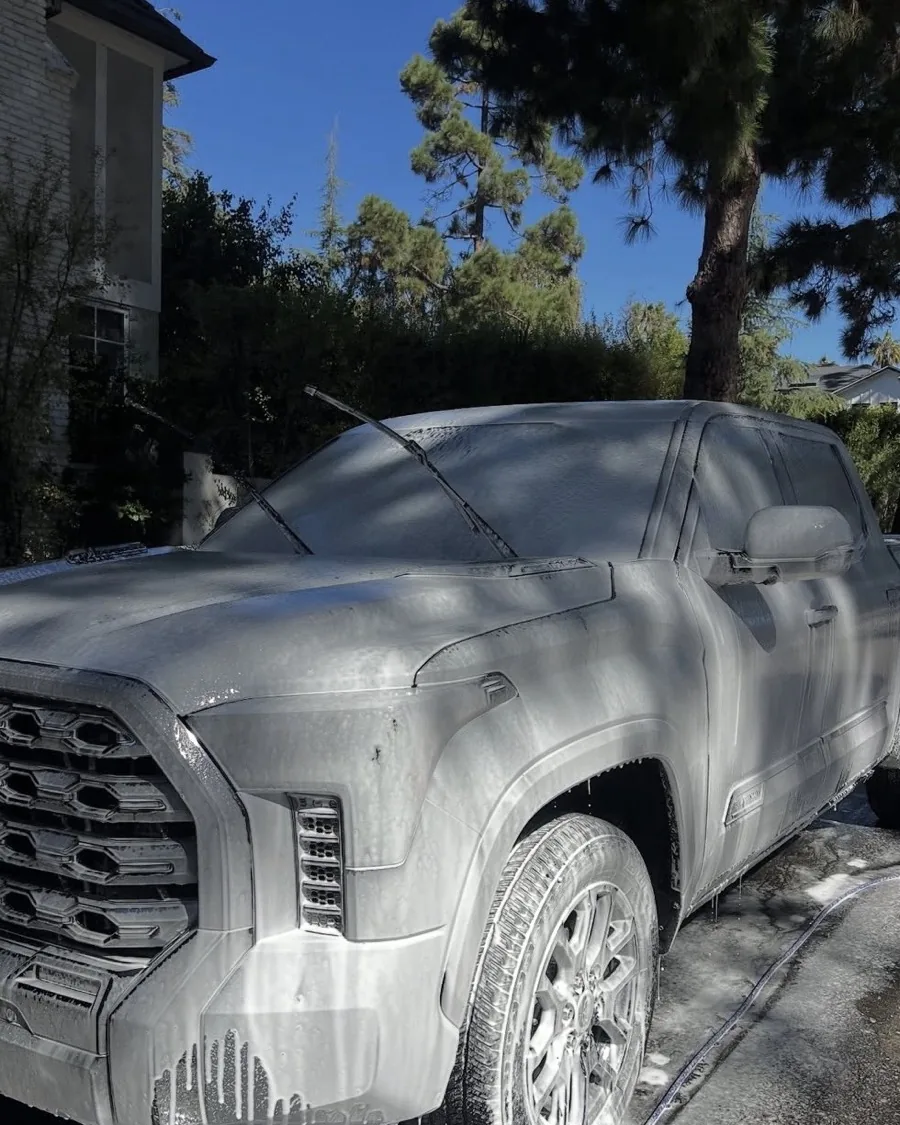 A Toyota Tundra covered head to foot in cleaning foam at the start of a detail
